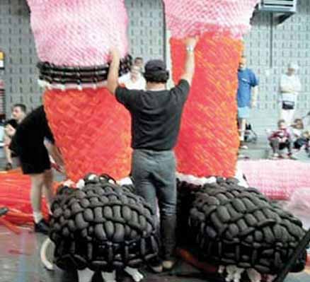 The feet and lower legs of what will become a 40-foot tall soccer player made of balloons.